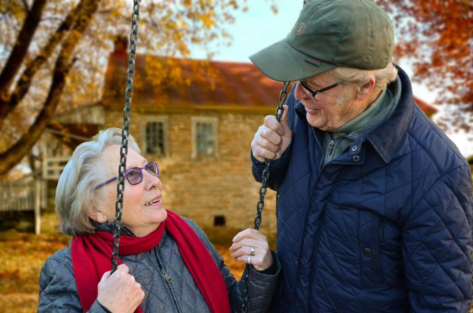 Senior couple outside on a swing
